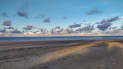 Crystal-clear blue waters meet the soft sands of Bainema Beach on Boipeba Island, Bahia, Brazil.