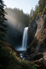 Obraz premium Majestic waterfall cascading in serene forest landscape with sunlight and mist