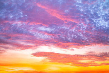 Obraz premium Beautiful , luxury soft gradient orange gold clouds and sunlight on the blue sky perfect for the background, take in evening,Twilight, Large size, high definition landscape photo