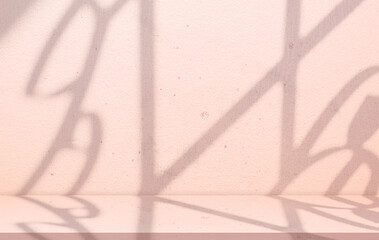 Minimal pink wall background with soft shadow window frame on shelf for product display.Studio interior room with cement floor mockup scene,cosmetic branding template,natural light abstract backdrop