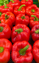 A vibrant, close-up view of a bountiful pile of fresh, ripe red bell peppers, perfect for healthy cooking and nutrition