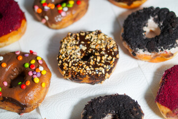 Various flavors of donuts arranged in a row