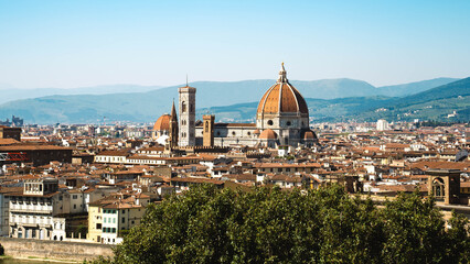 Naklejka premium Florence skyline at golden hour with Cathedral of Santa Maria del Fiore (Duomo) and terracotta rooftops, Italy