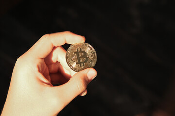 Cryptocurrency concept. Bitcoin in hand. Digital currency in hand.