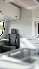 Interior of a camper van with bright white tones, featuring a table and two seats