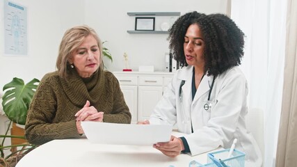 A Diverse Female Doctor Consults With Her Mature Female Patient About Health and Wellness - Powered by Adobe