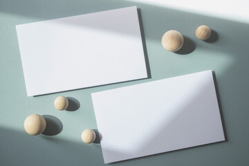 Empty white blank greeting or invitation card with wooden ball on blue background. Mock up presentation.