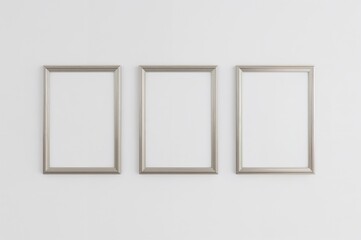 Three empty picture frames suspended on a wall with space for text