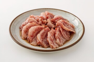 Delicately cut pork served on a traditional ceramic dish