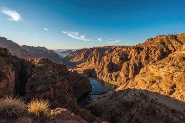 Obraz premium The valley beside the river glows with a golden hue.