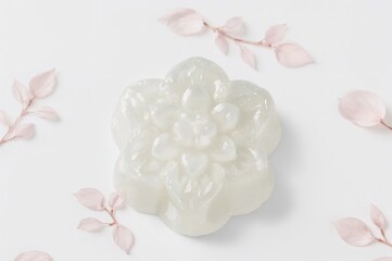 Traditional Thai dessert shaped like a flower made from coconut milk jelly on a white background