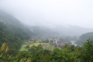 Fototapeta premium Shirakawa-go, Japan – 4 Oct 2024: Panoramic view of Ogimachi village from Ogimachi Castle Observation Deck. Traditional Gassho-zukuri houses and landscapes highlight this UNESCO World Heritage site.