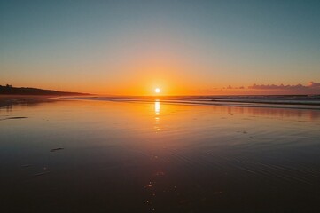 Obraz premium Dawn breaks over a serene coastal shore