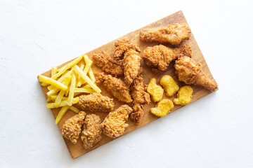 Chicken wings, breasts, legs, nuggets fries and French fries. Fast food. American cuisine.