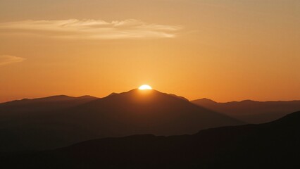 Fototapeta premium Mountain outlines with sun and haze in a natural park