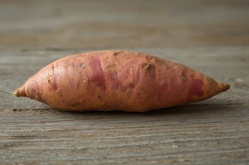 Sweet potato resting on a wooden table
