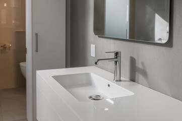 Fototapeta premium Contemporary bathroom featuring a sleek white basin