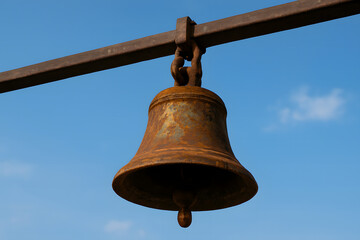 Rusty Temple Bell Against Blue Sky