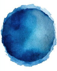 Abstract watercolor painting of a blue circle on white paper close up with textured edges and gradient wash effect in studio