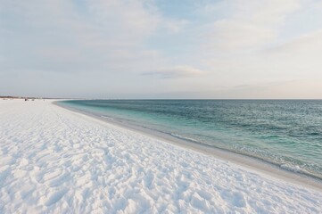 Obraz premium Sunrise over a snowy coastline by the sea