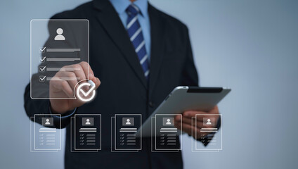 Businessman using digital checklist with resume documents and approval icons on tablet. Concept of recruitment job application candidate evaluation and human resource management in business