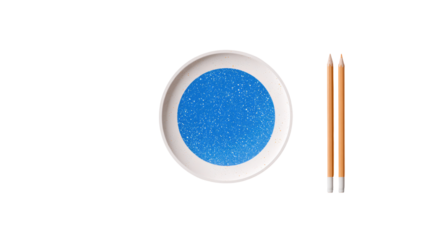 A white plate with a speckled blue design, alongside two pencils