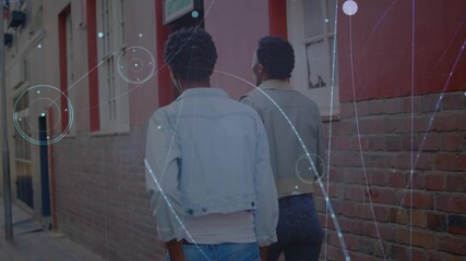 Animation of connections over back view of african american male friends walking on street - Powered by Adobe