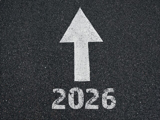  happy new year - 2026 and an arrow written on an asphalt road