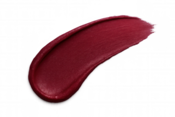 Rich red lipstick sample displaying creamy, glossy texture against transparent backdrop, highlighting cosmetic detail for beauty industry uses
