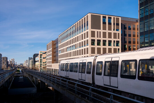 Elevated metro line in Ørestad, Copenhagen, Denmark, surrounded by modern residential buildings, symbolizing progress, mobility and Scandinavian sustainable transport