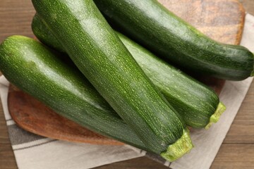 Fresh ripe zucchinis on wooden table, top view