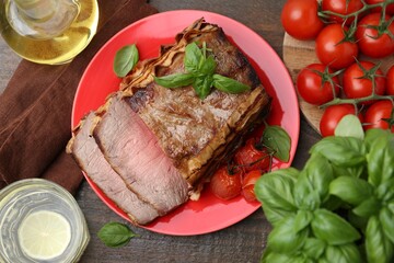 Delicious baked beef meat, tomatoes, basil and refreshing drink on wooden table, flat lay
