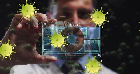 Animation of virus yellow cells over caucasian male doctor with digital card with virus data - Powered by Adobe