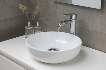 Fototapeta premium Contemporary ceramic sink with artistic faucet