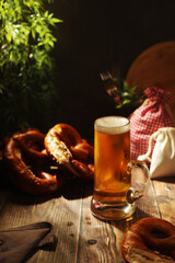 A mug with beer and traditional German bretzels in Bavarian rustic style