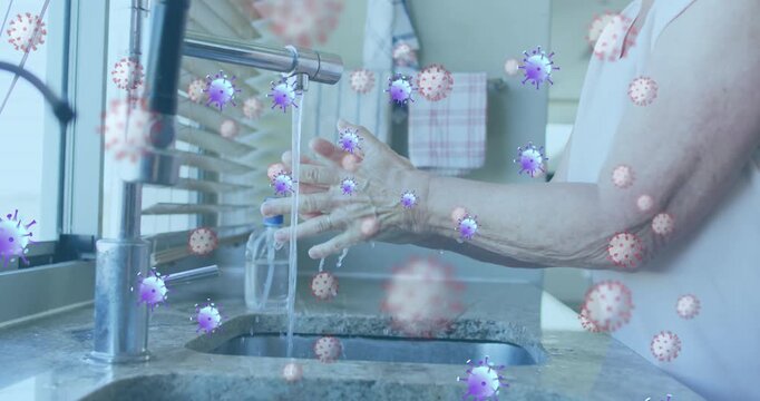 Animation of purple virus cells over hands pf caucasian senior man washing hands