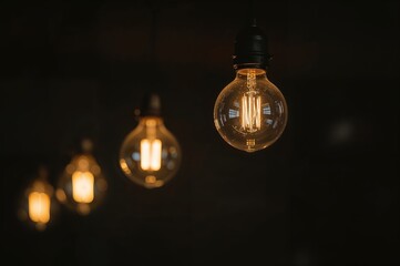 Detailed shot of glowing lights against a dark backdrop with bokeh, highlighting themes of commerce, innovation, style, nostalgia, creativity, illumination, ideas, classic, dining venue