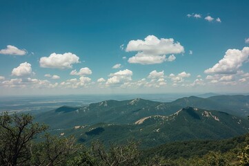 Experience the serenity of the great outdoors with stunning mountain vistas under a clear blue sky