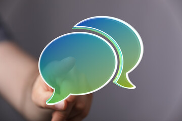 Abstract image of a hand interacting with vibrant speech bubbles, symbolizing communication and digital interaction.