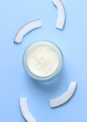 Cosmetic jars and coconut on the table close-up and place for text. . Vertical photo format