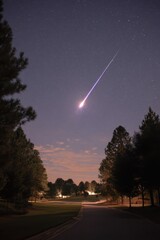 Dramatic Meteor Streaking Across Night Sky Over Suburban Landscape Long Exposure Shot