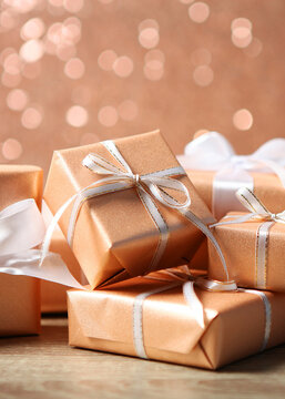 Gifts in gold packaging on a colored background with place for text. . Vertical photo format