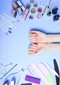 Top view of the hands of woman with professional nail care tools for manicure. Vertical photo format