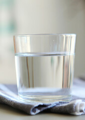 Clear water in a glass and bottle on the table. Vertical photo format. Vertical photo format