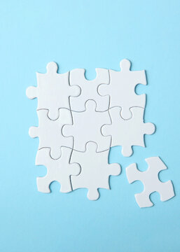 White puzzle on a colored background top view.. Vertical photo format