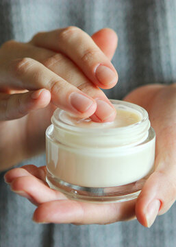 girl smears her hands cosmetic cream. skin care,. Vertical photo format