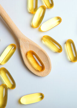 Omega 3 capsules on a white background with place for text. . Vertical photo format