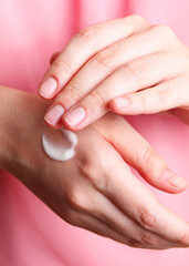 female hands and jar of cream close-up with place to text.. Vertical photo format