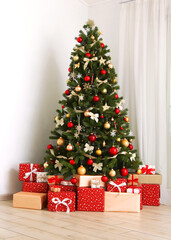 Beautiful interior decorated for Christmas or New Year.Christmas tree and gifts.. Vertical photo format