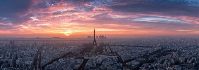 Panoramic view of Paris at sunset, showing the Eiffel Tower and cityscape